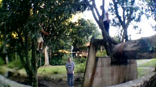 Three kids playing parkour on concrete