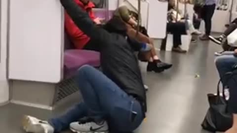 Guy tries to do back flip off of subway handle bars falls to ground