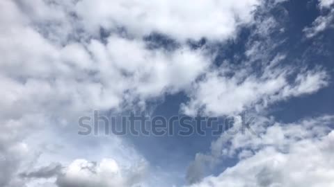 Timelapse moving clouds on a blue sky background