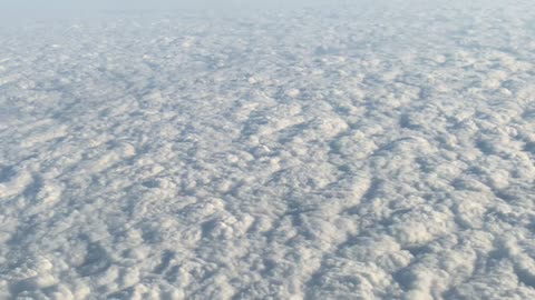 Clouds seen through the window from inside an airplane