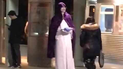 Man in white and purple robe outfit