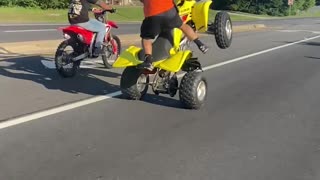 Man on Yellow Four-Wheeler Pulls Impressive Stunts