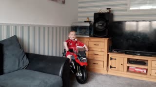 Boy riding motorcycle in house
