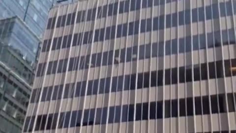 Person starts throwing large patio furniture off of the roof of a skyscraper in midtown Manhattan