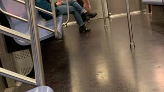 Drunk man with pink cowboy hat costume spins on subway