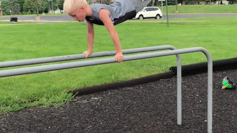 Little boy in grey playground front flip fall