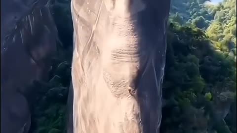 Climb rocks shaped like seals on Mount Danxia.