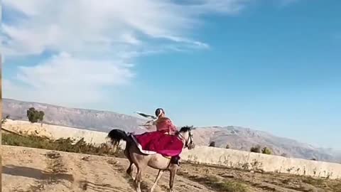 Horse riding woman in local dress