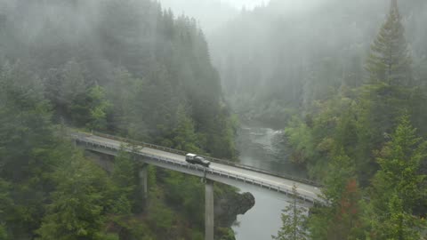 A Drone Footage of Moving Car on the Bridge