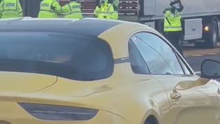 Police Escort People Out of Truck's Trailer