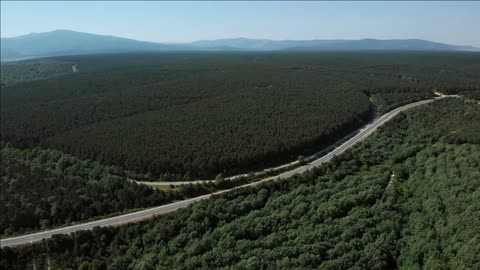 natural landscape with hills trees forest and highway near burgos in spain