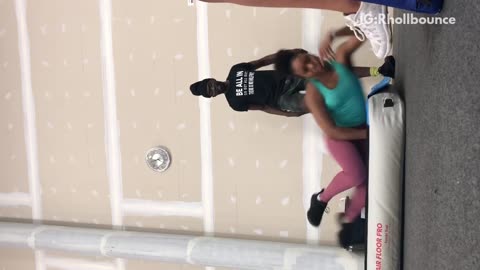 Girl blue shirt pink pants back flip fail