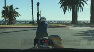 Motorcycle with a rainbow surf board