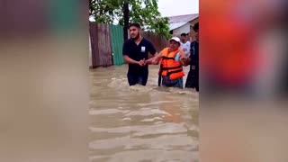 Ecuadoreans use ropes to evacuate flooded areas