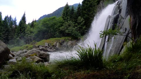 waterfall from the mountain with green forest