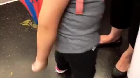 Little girl subway doing the floss with one arm glasses