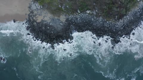 Top aerial shot of seashore with rocks