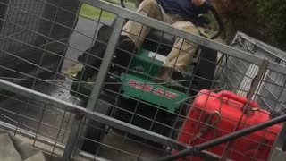 Man on Mower Takes a Tumble