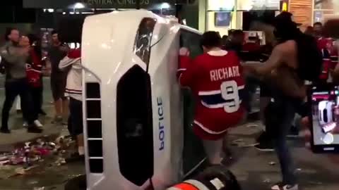 Habs fans flip over a police car after Game 7 win on June 24
