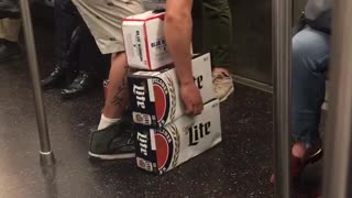A guy in red shirt hat trying to carry beer