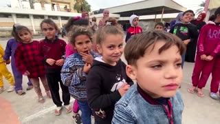 Volunteers play with children sheltering in Khan Younis