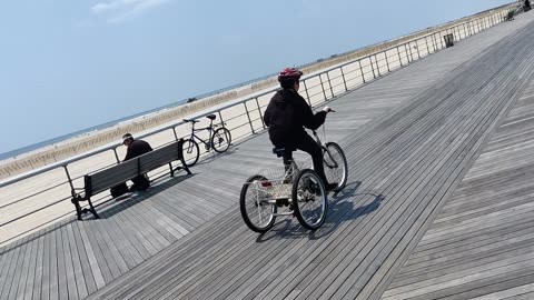 Spencer riding his tricycle at Jones beach air show VID_20230521_125838