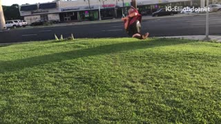 Guy in red spins on grass falls on back