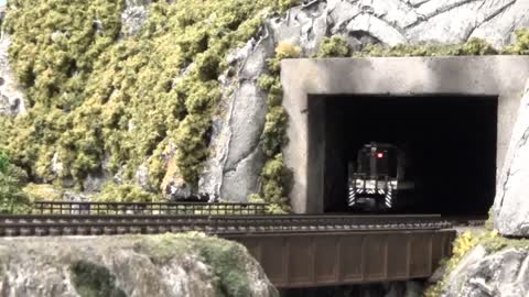A 1950's Southern Freight Train Emerges From A Smoky Mountain Tunnel