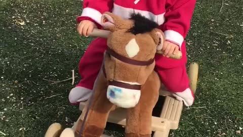 Little rider saddled pony