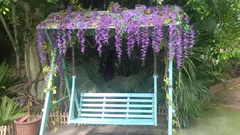 This blue flower surrounds the bench