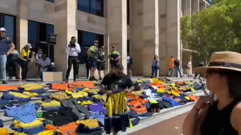 Patriots in Australia laying down their work uniforms on the steps of parliament