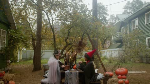 Children Wearing Halloween Costume While Sitting on the Bench