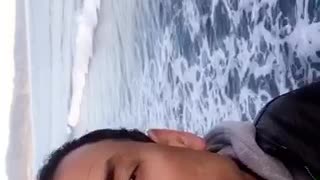 Guy talking to camera at the beach