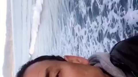 Guy talking to camera at the beach