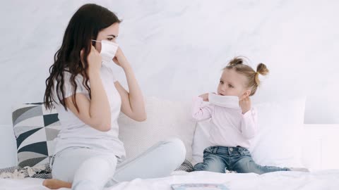 Cute kid learning to put on mask