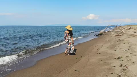 Woman walking along the sandy beach