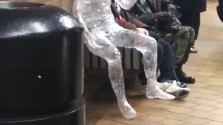 Ice statue of a person on bench on subway