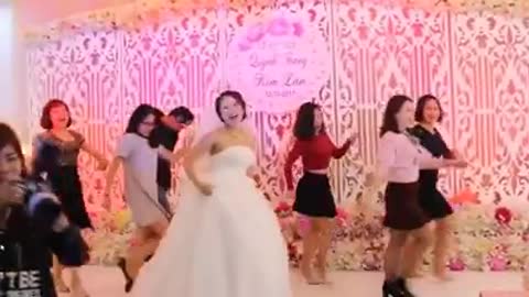 Bride with friends dancing jubilantly in her wedding
