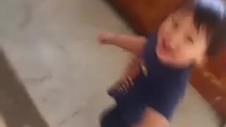 Little kid boy hanging to jacket spin falls on ground