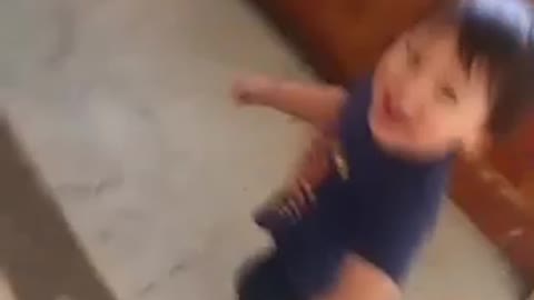 Little kid boy hanging to jacket spin falls on ground
