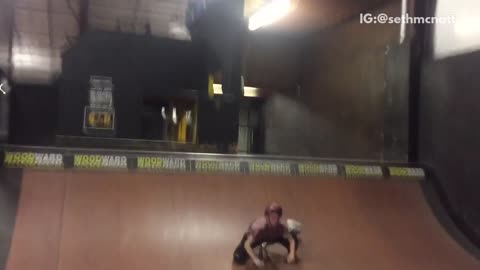 Guy does back flip on scooter at a skatepark and falls