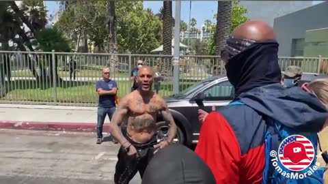 Man smacks an antifa in the face with a rosary