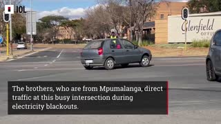 Unemployed brothers direct traffic during load shedding