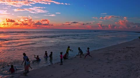 Happy children playing on the beach