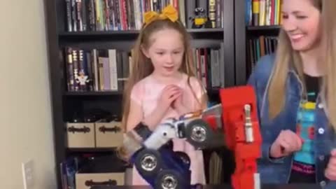 Little girl amazed at the robot