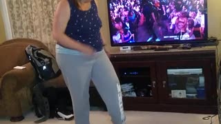 Woman in blue imitates dance on tv