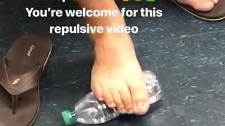 Man rolls foot on water bottle
