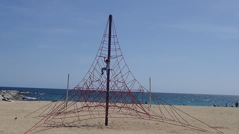 Kid Playing Besides A Sea Beach