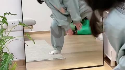 cute baby jumping in front of the mirror