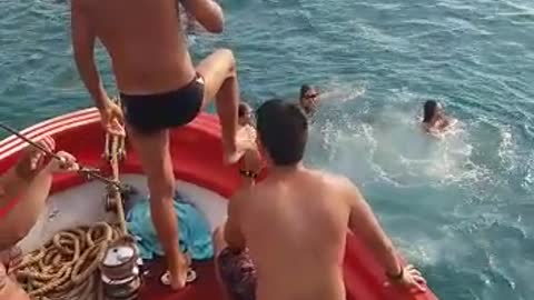 Guy slips on red boat falls into water